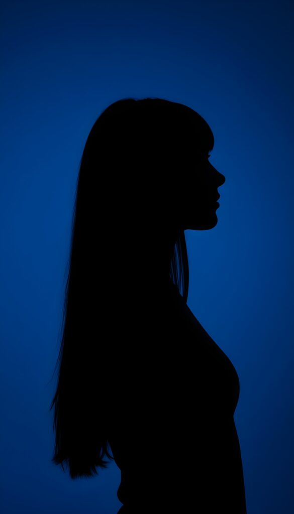 A (((black silhouette of a young girl with long straight hair))), perfect curved female figure, all against a deep blue backdrop, side view.