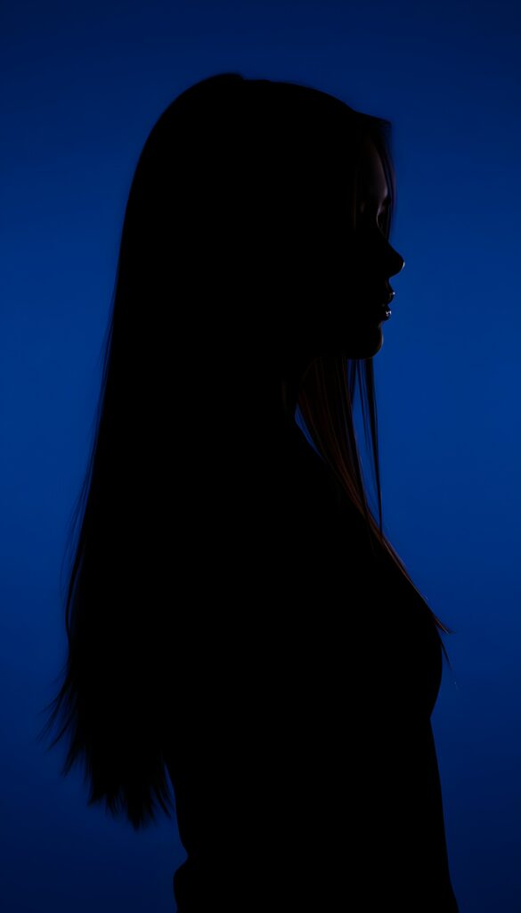 A (((black silhouette of a young girl with long straight hair))), perfect curved female figure, all against a deep blue backdrop, side view.